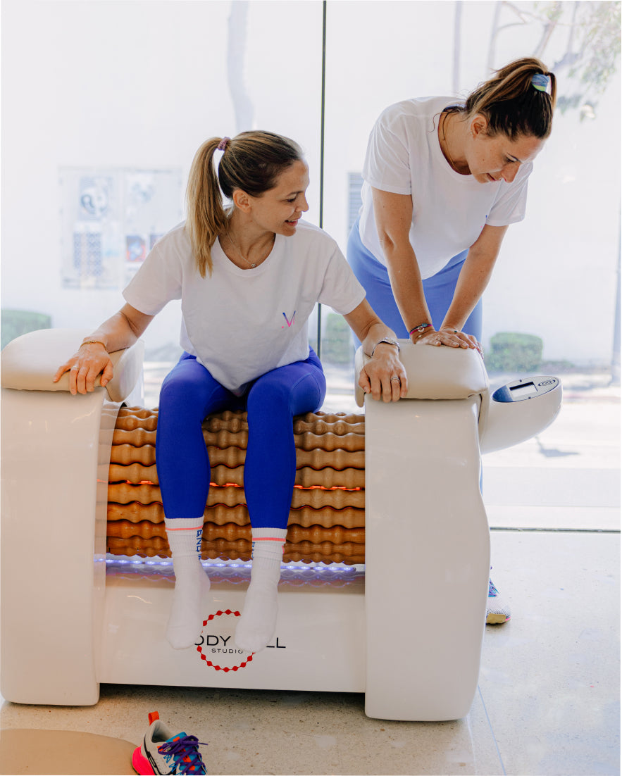 Women testing out the Body Roll Machine