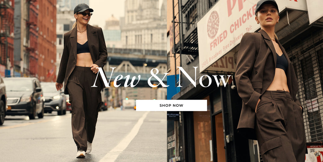 Model Ellie Thumann wearing a brown suit from Herskind and a black bralette in the Lower East Side with the words  New & Now: Shop Now 